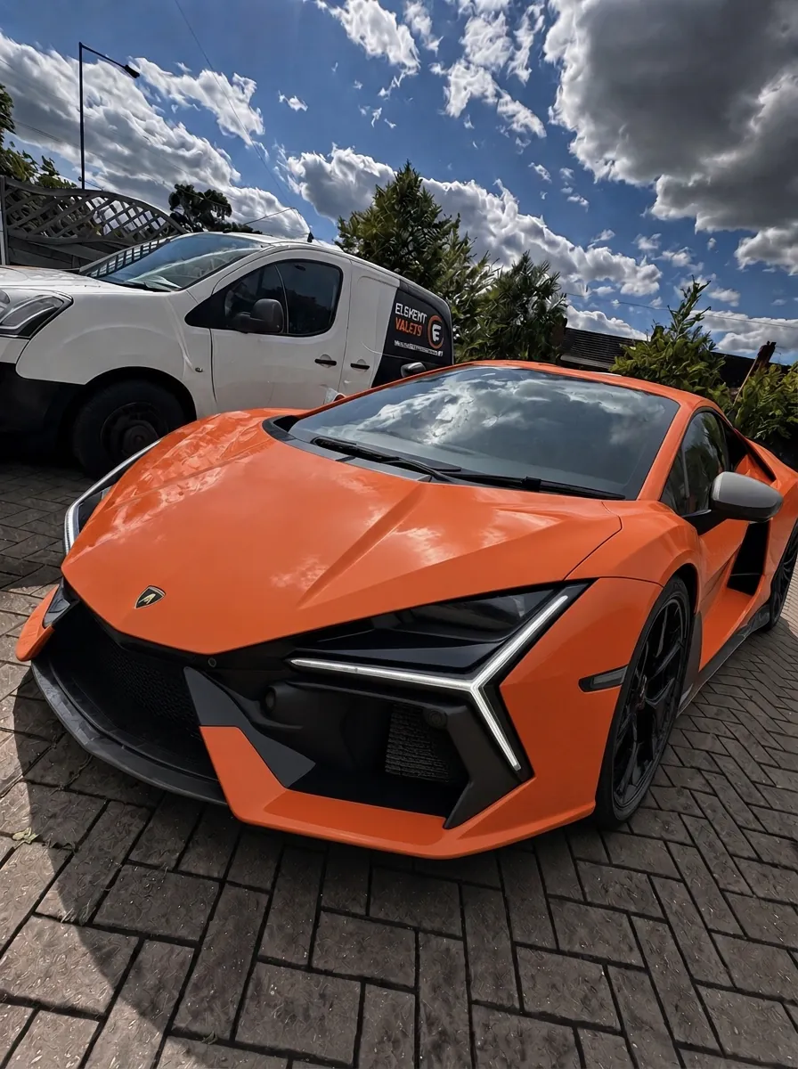 Orange Lamborghini detailed by Element Valets, alongside our branded van